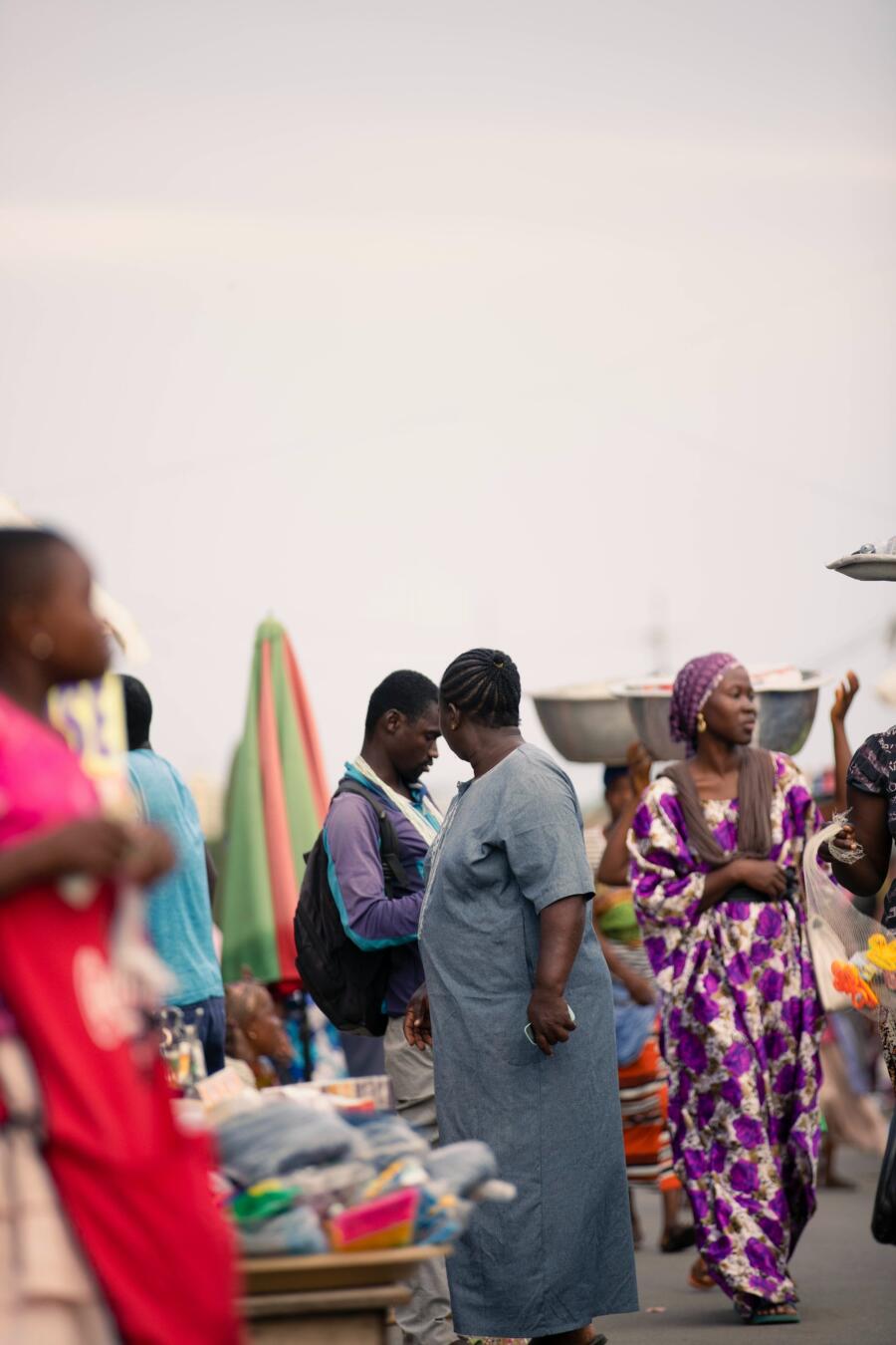 Shoppers and traders at an African market, reflecting consumer demand across connected sectors