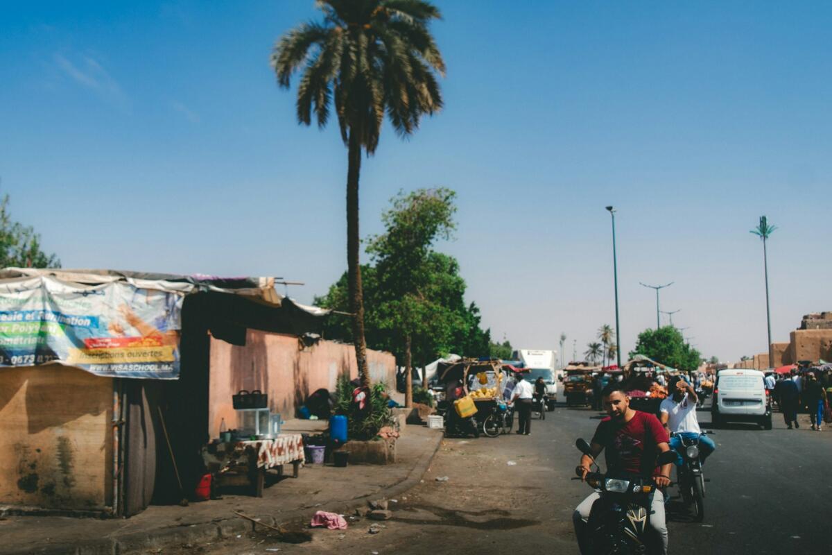 Busy African street with traders and traffic, showing the local operating environment investors must navigate
